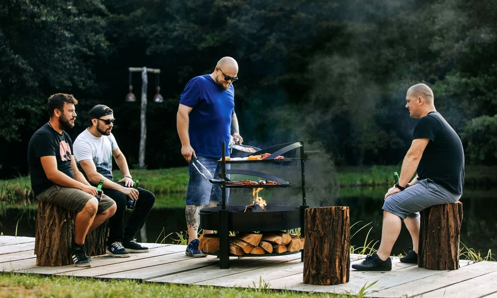 Friends grilling around a COOK KING fire bowl